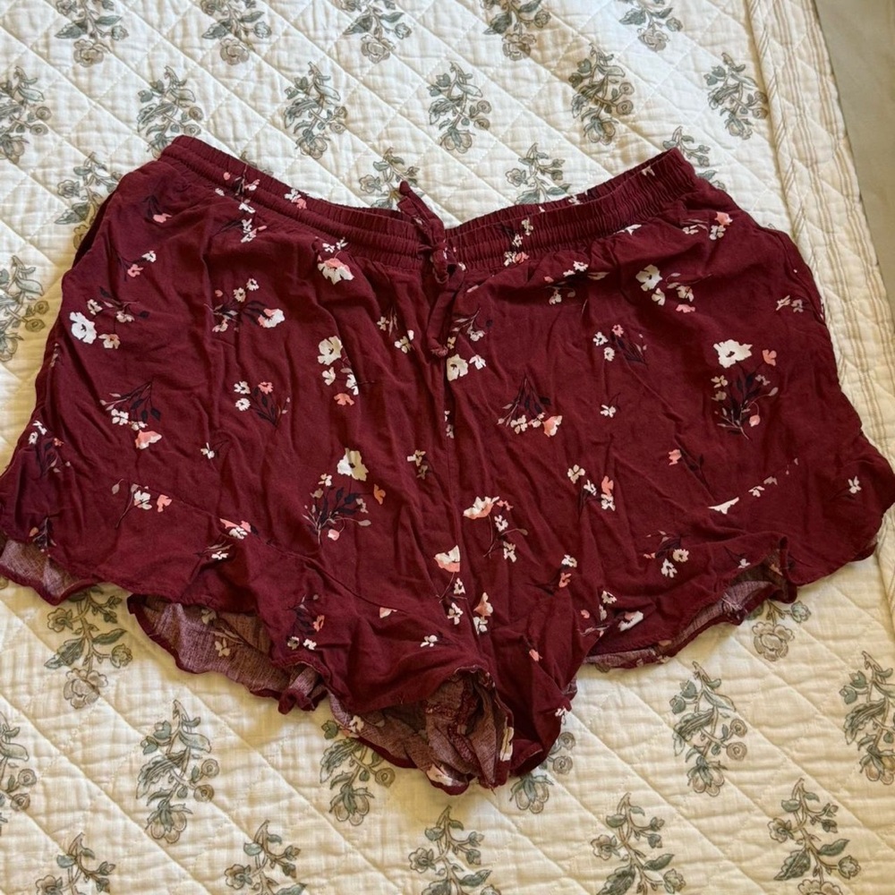 Burgundy floral Mossimo shorts with tie waist and ruffle bottom- size large.